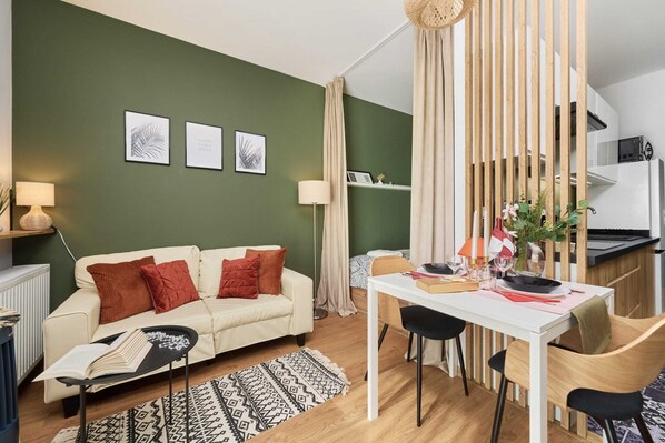 The living area features a sleek coffee table and a flat-screen television.