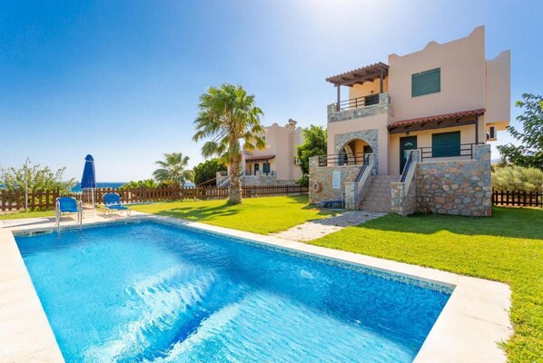 Beautiful villa with private pool, terrace, and lawn with sea views