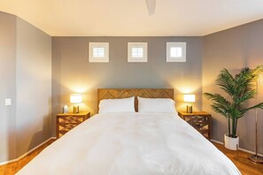 Comfy queen size bed with cozy white bedding
