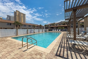Poolside relaxation with sparkling water, inviting loungers, & pure tranquility.