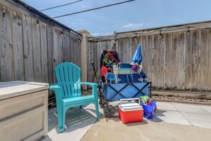 Beach amenities add convenience with a cooler, umbrella, toys, chairs, and cart.