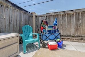 Beach amenities add convenience with a cooler, umbrella, toys, chairs, and cart.