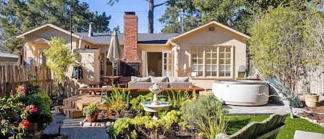 3 sets of french doors lead to a beautiful large sunny backyard with a hot tub,  outdoor shower, fireplace, and fountain. The house is on a 5,000 sq ft lot and both the front and backyard are fully fenced in-great for dogs.