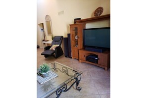 Living room with TV, massage chair, & real sound system!