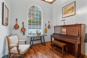 Create some wonderful melodies playing the piano in the music room/ office space.