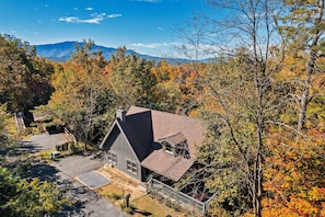 The cabin awaits, at the top of the ridge, surrounded by nature.