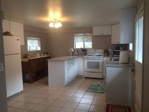 Large kitchen with all appliances, pots and pans to cook your meals.