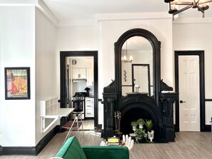 Views to the kitchen and bathroom from the closet. Stylish original prints and fun amenities like the Roku TV.