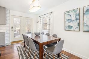 Dining area seats up to 8 and the doors lead to the deck overlooking the backyard