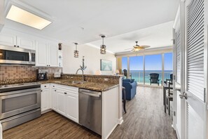 The fully equipped kitchen features granite countertops and stainless-steel appliances.