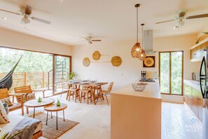 A soothing natural open living space where the living, dining room, and kitchen