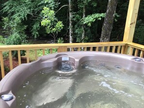Soak in mountain views and fresh forest air from your private hot tub hideaway.