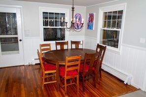 Dining area with 7 chairs. 3 bar stools at island in same area.