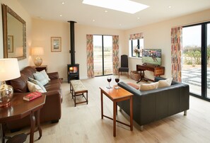 Evenwood Byre, Shropshire: Sitting room with wood burning stove