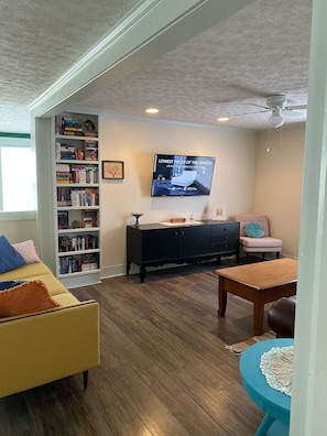 A smart TV, variety of books, games and children's toys are available.