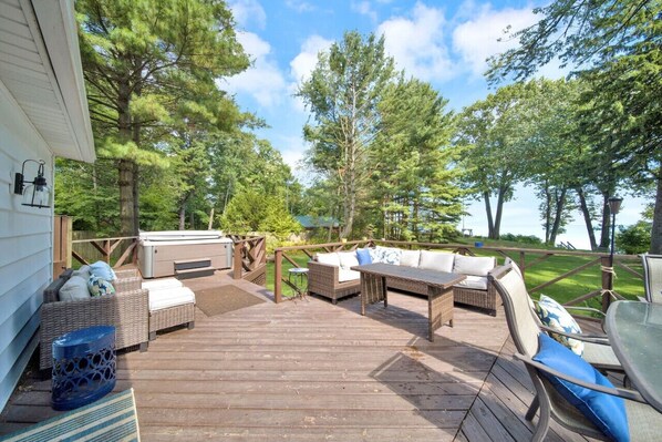 Large deck off the back of the home with a hot tub!
