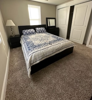 main floor first bedroom queen size bedroom with TV. 