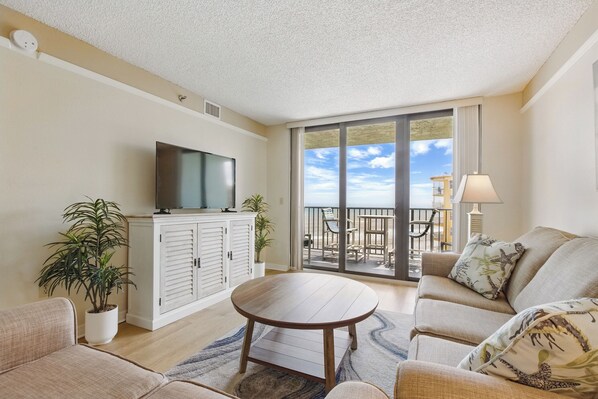 Spacious living room with balcony access.