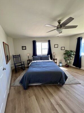 Guest Bedroom with a queen bed.  There is also a dresser with TV in the room.