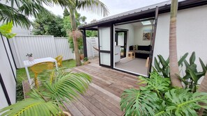 French doors open out onto decks surrounded by tropical gardens.