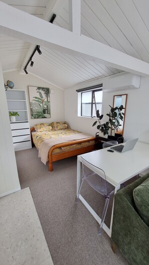 Bedroom area with wardrobe with storage. Dining table/ desk. 