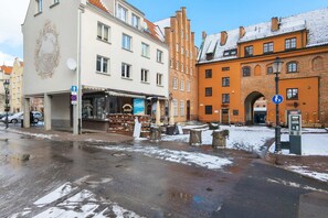 An exterior view of the apartment building in a charming neighborhood, surrounded by historic architecture.
