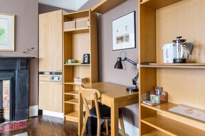 Dining and or study area, with wifi and desk lamp and 2 chairs.