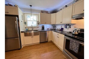 Upgraded kitchen with stainless appliances and leathered granite countertops.