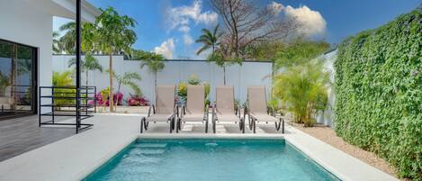 Stunning tropical space outside in the private and serene back patio with a sparkling pool!