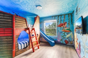 Our Under the Sea themed bedroom will transport you to an underwater wonderland, where mermaids and fish friends await your dreams!