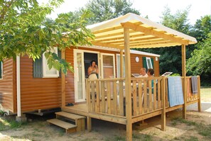 Charming camping home with a covered porch, ideal for relaxing outdoors.