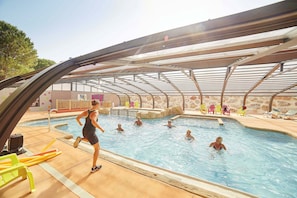 Indoor pool with a retractable roof, allowing for swimming in any weather.