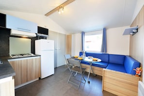 Bright and welcoming, the open-plan living space offers a cozy nook for relaxation and dining in comfort.