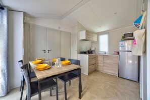 Bright and welcoming, the dining area offers a simple yet comfortable spot to enjoy meals and conversation.