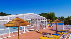 Relax in style by the outdoor pool, complete with shaded areas for a perfect day under the sun.