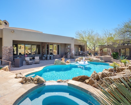 Stunning Cave Creek home with sparkling pool, spa, covered patio with shuffle board, outdoor dining, BBQ grill, fire pit, sun loungers, and private guest casita that features a sauna!