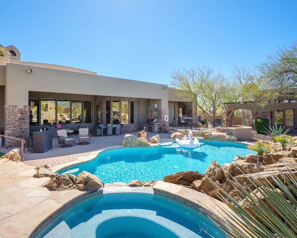Stunning Cave Creek home with sparkling pool, spa, covered patio with shuffle board, outdoor dining, BBQ grill, fire pit, sun loungers, and private guest casita that features a sauna!