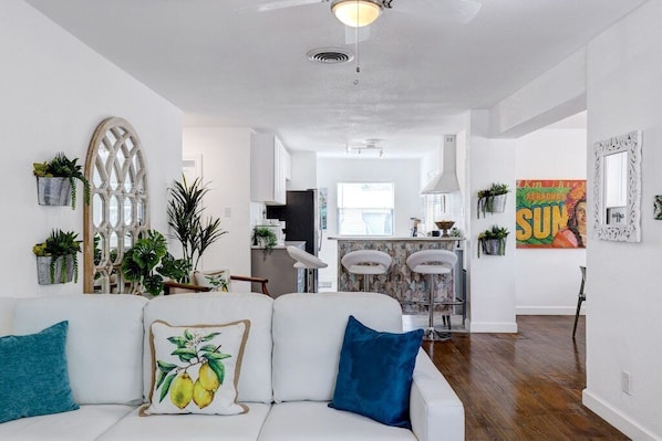 Amazing open concept living room and kitchen adorned with beautiful décor.