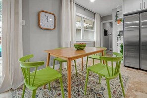 Breakfast table with green chairs