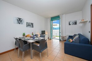 Living room, dining area and access to the balcony