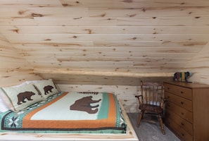 Queen bed in the upstairs bedroom