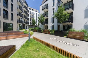 A landscaped courtyard with benches and greenery, providing a serene outdoor space for guests.
