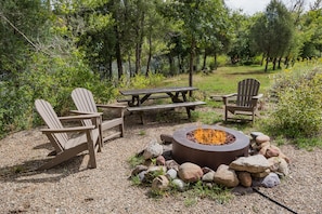 Gas firepit with seating on the Animas River