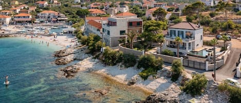 Aerial view of the luxury estate of the villa Sensation with pool, jacuzzi, and garden  with its surroundings at the seafront on Ciovo