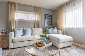 Relax in our cozy living room with a queen bed for 2 extra guests.