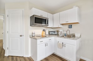 Microwave, 2 Burner Cooktop, Toaster Oven, and Coffee Maker.