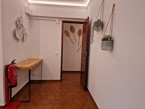 Bright and spacious living room with desk and work chair and flat screen TV.