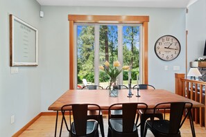 Dining room seating 6. Large windows overlook the backyard.
