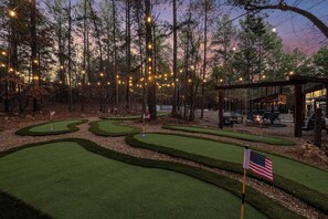 Day or night, our 6-hole glow mini golf course beneath towering pines invites you to unwind and connect. Imagine friendly competition under the stars, laughter echoing through the trees, and lasting memories made!