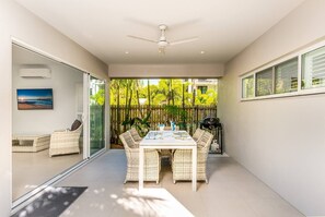 The living area flows seamlessly to the undercover patio, where you'll find a dining setting with BBQ